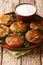 Aloo tikkiÂ is a popular Snack across India made using mashed potatoes close-up in a plate. vertical